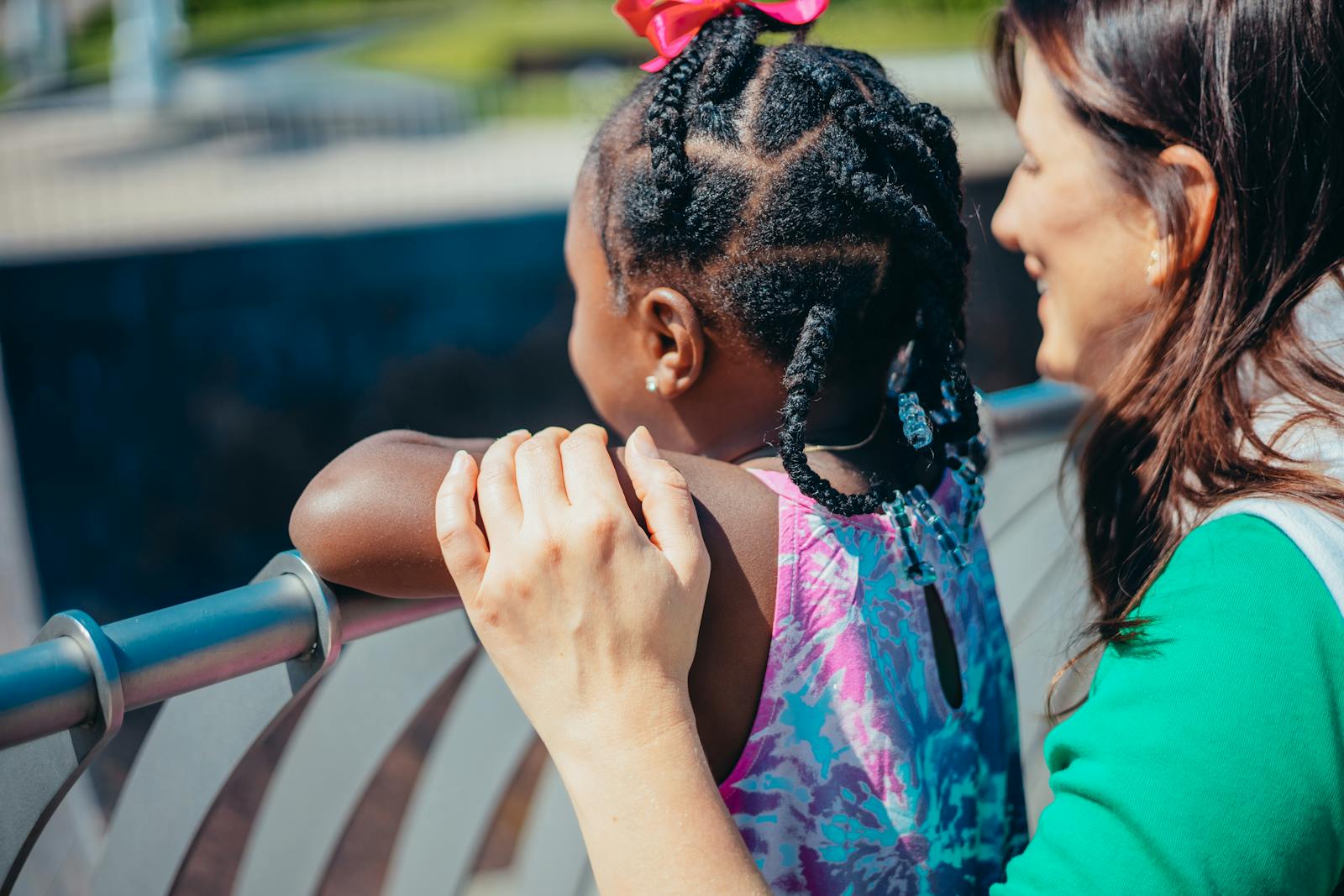 A heartwarming moment between a mother and daughter enjoying time outdoors.